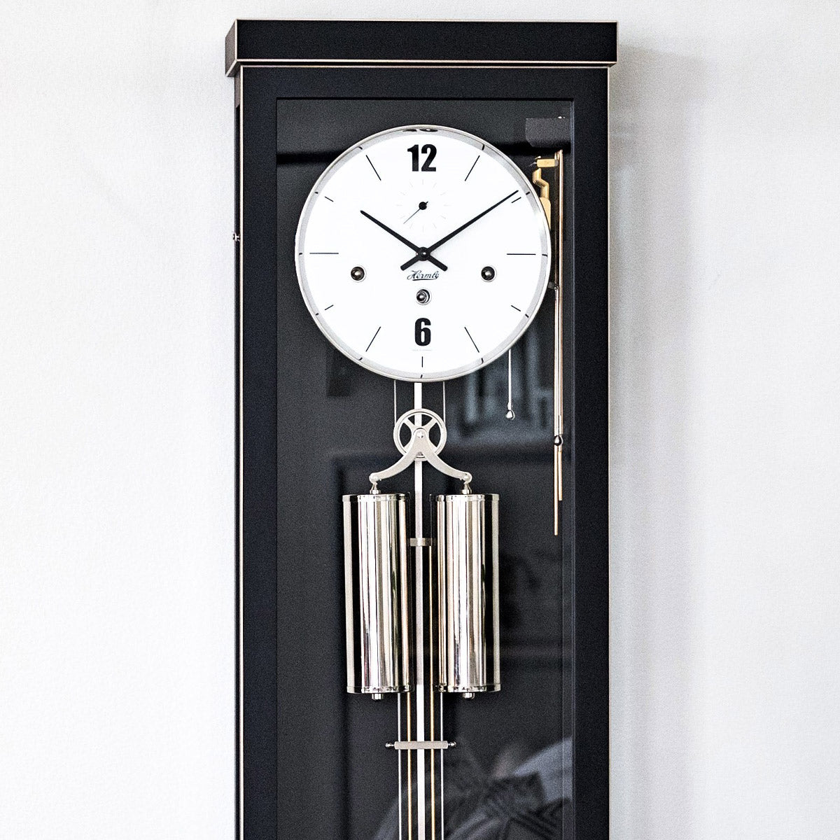 Abbot regulator wall clock face and weight close-up