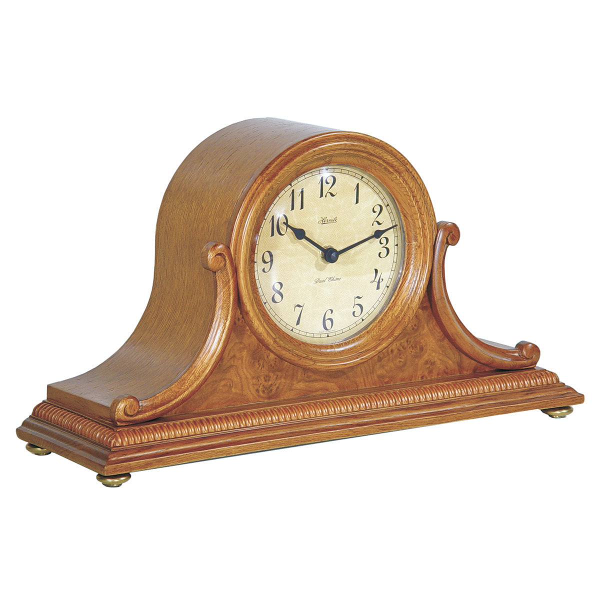 Light oak wood Tambour style mantel clock with ornate design on white background.