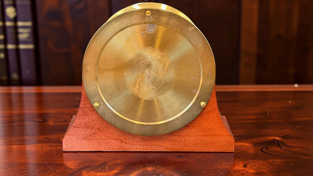 Back of Chelsea Newport polished brass clock with wooden stand