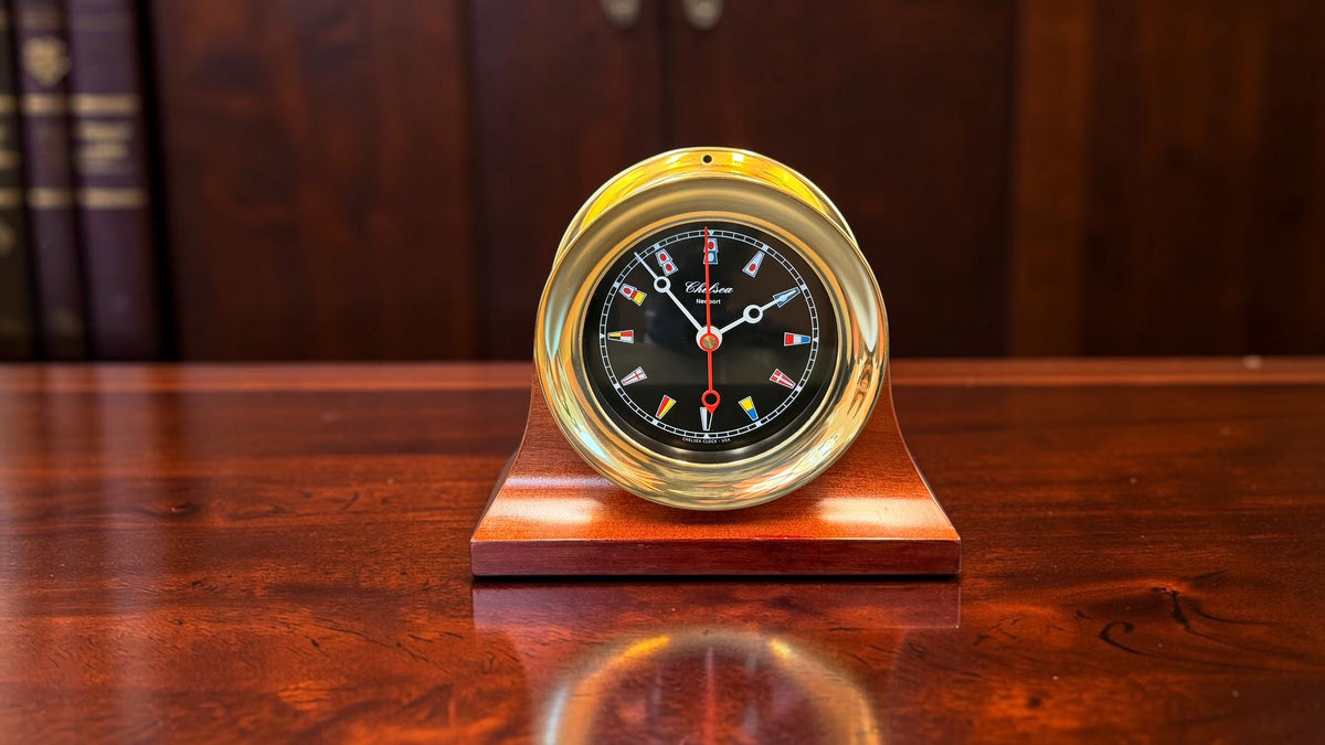 Vintage Chelsea Newport nautical flag desk clock, lustrous brass case on polished wood base