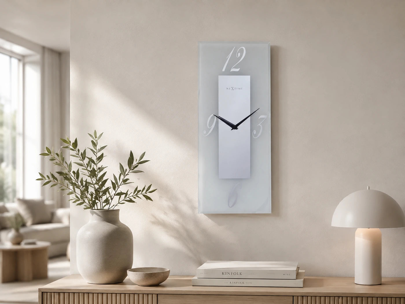 NeXtime rectangular glass wall clock above a console in a light interior