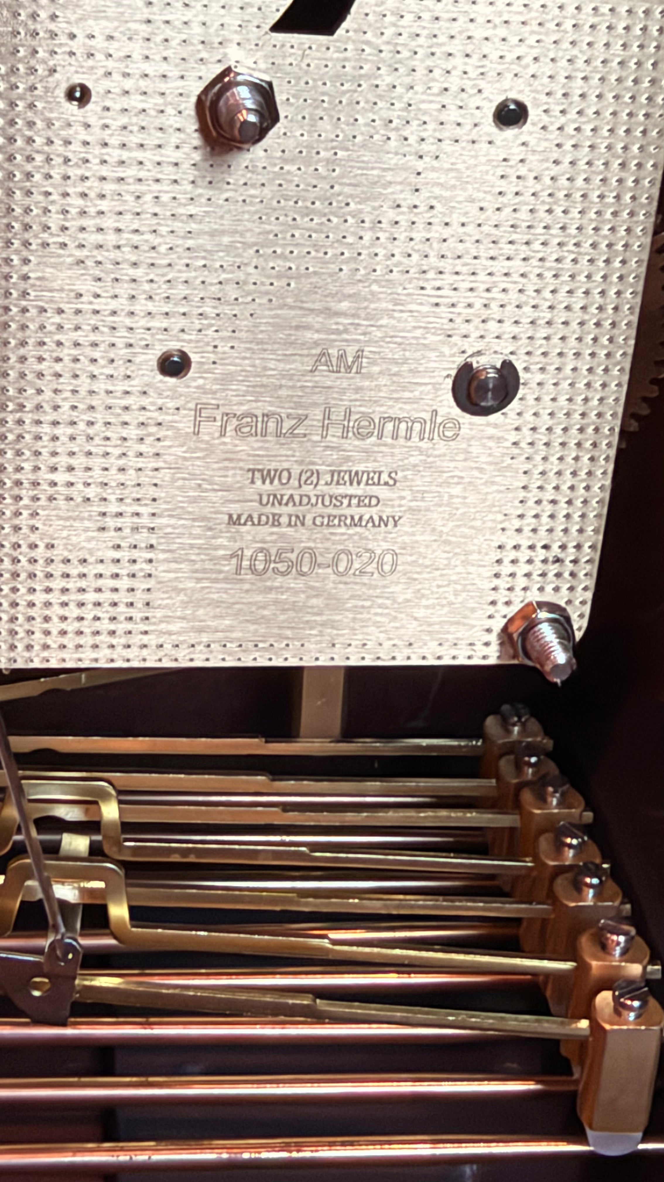 Hermle mechanical clock movement showing the date code and model number stamped on the back plate