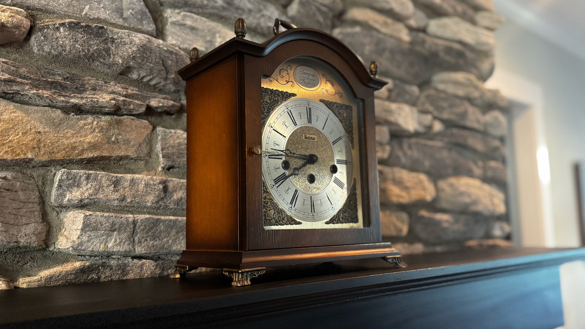 Gram’s arched Bulova mantel clock with brass-colored dial and Roman numerals on Andy’s mantel.