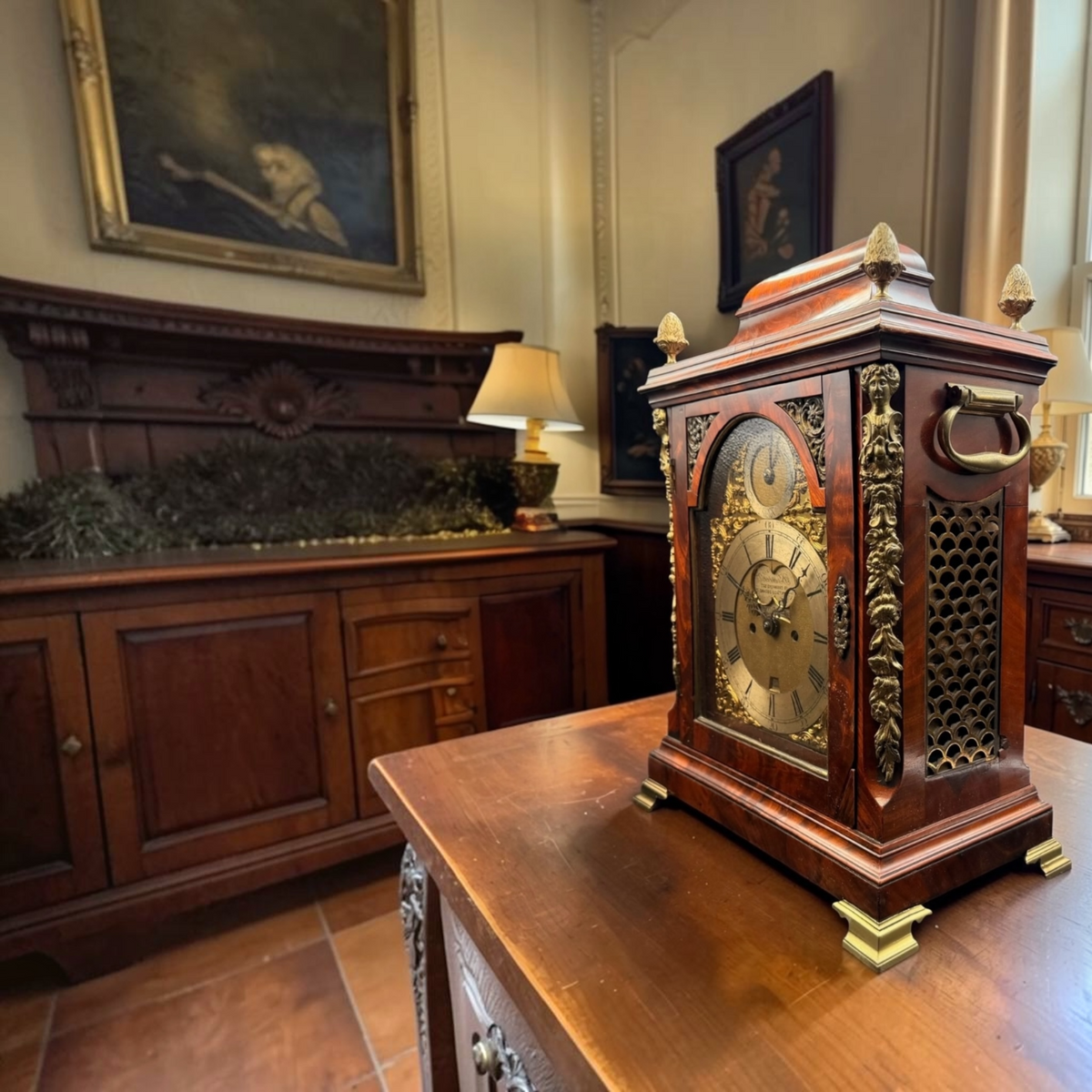 Ornate wooden mantel clock displayed in a traditional room