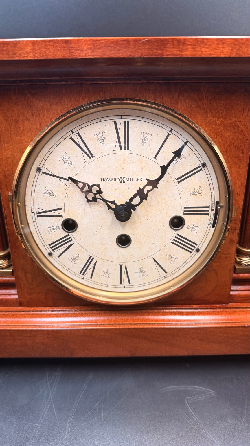 Howard Miller Circa aged Roman numeral dial with three winding holes