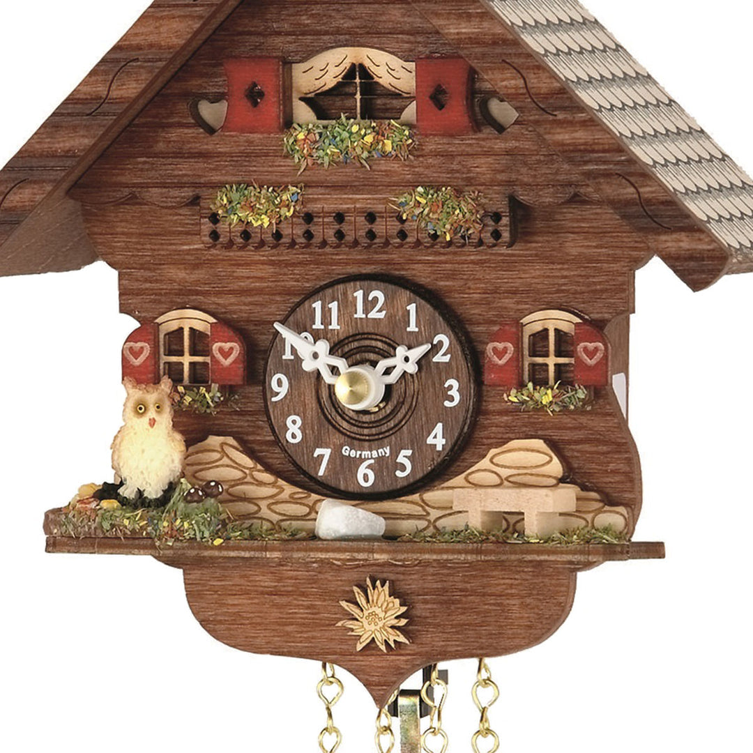Close-up of Trenkle Otto cuckoo clock dial, chalet details and white owl