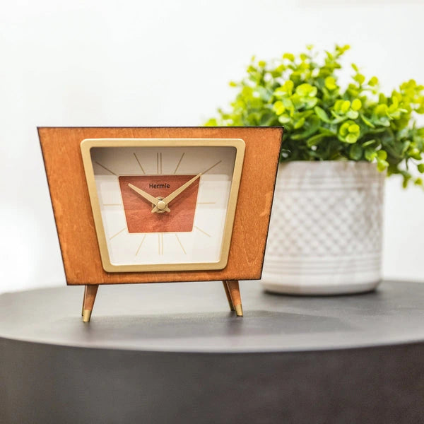 Hermle Margo wooden quartz mantel clock on a console beside a plant