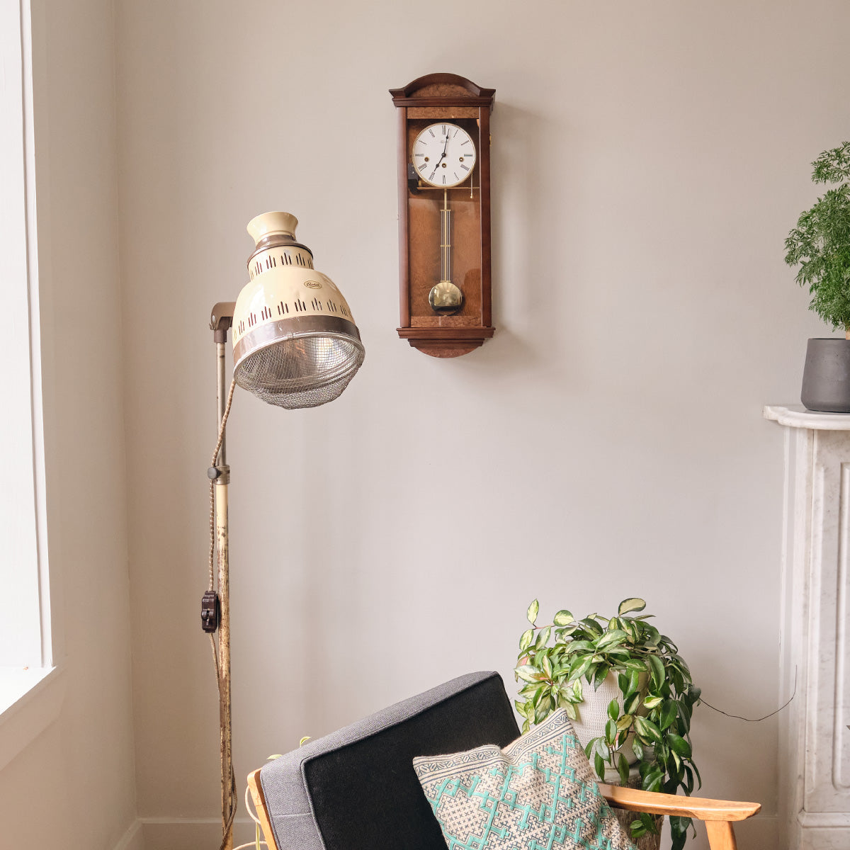 Hermle Isabella regulator wall clock beside a reading lamp